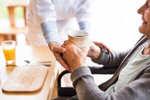 Personal i äldreomsorgen hjälper äldre person